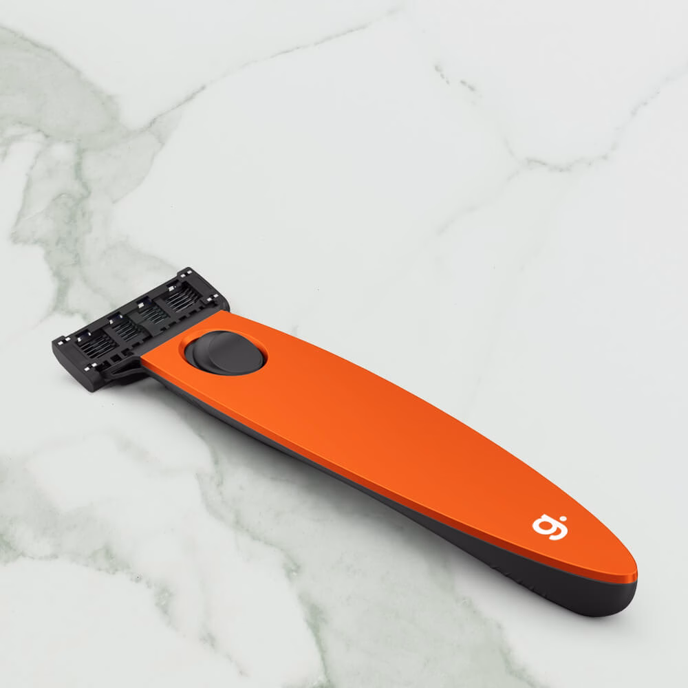 Orange razor on marble surface.