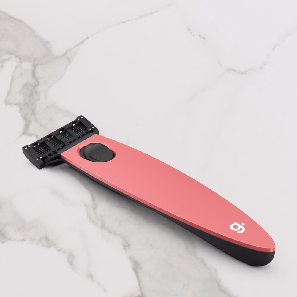 Pink razor on marble surface.