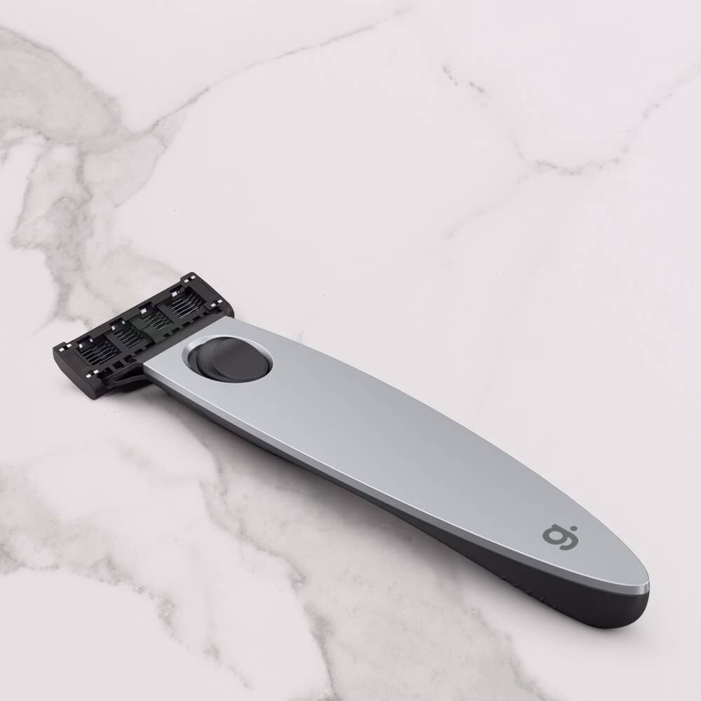 Silver razor on marble surface.