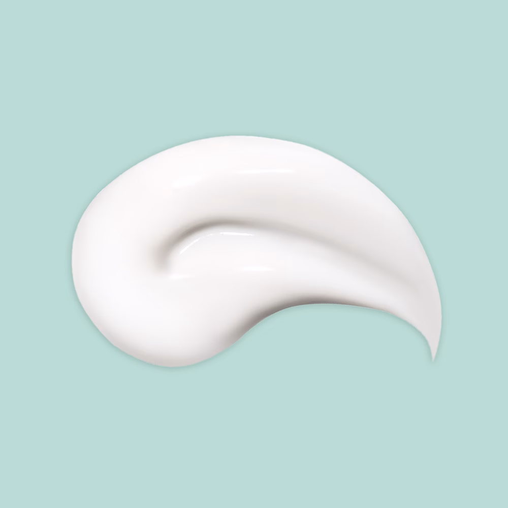 White cream smear on teal background.