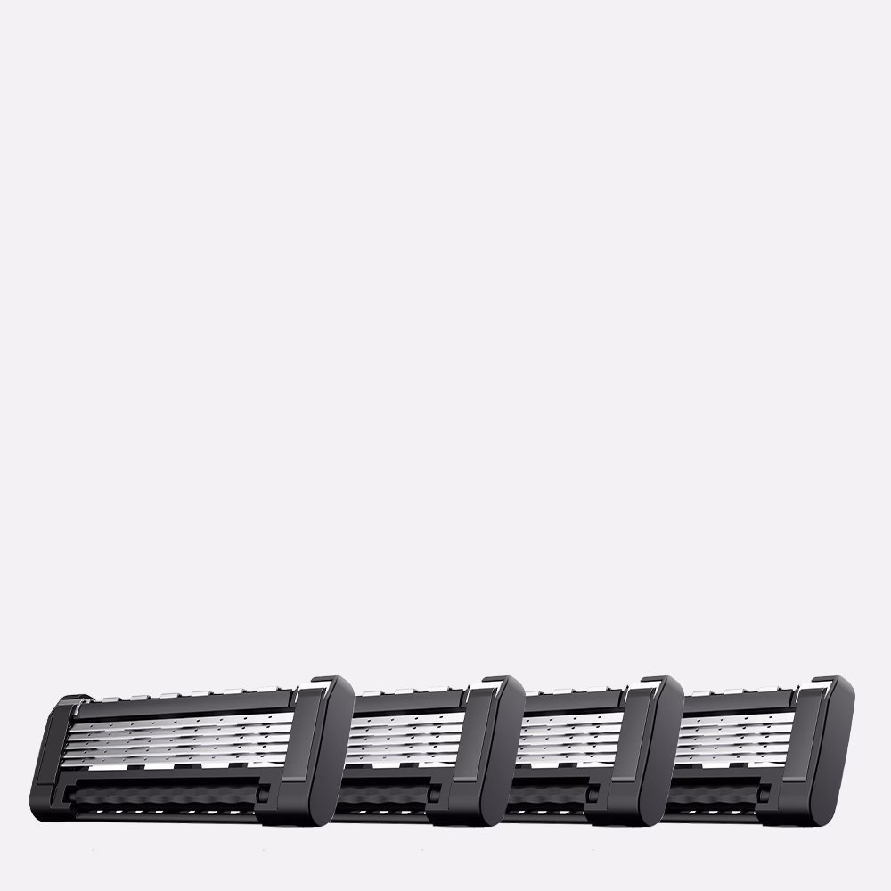 Four razor blade cartridges lined up.