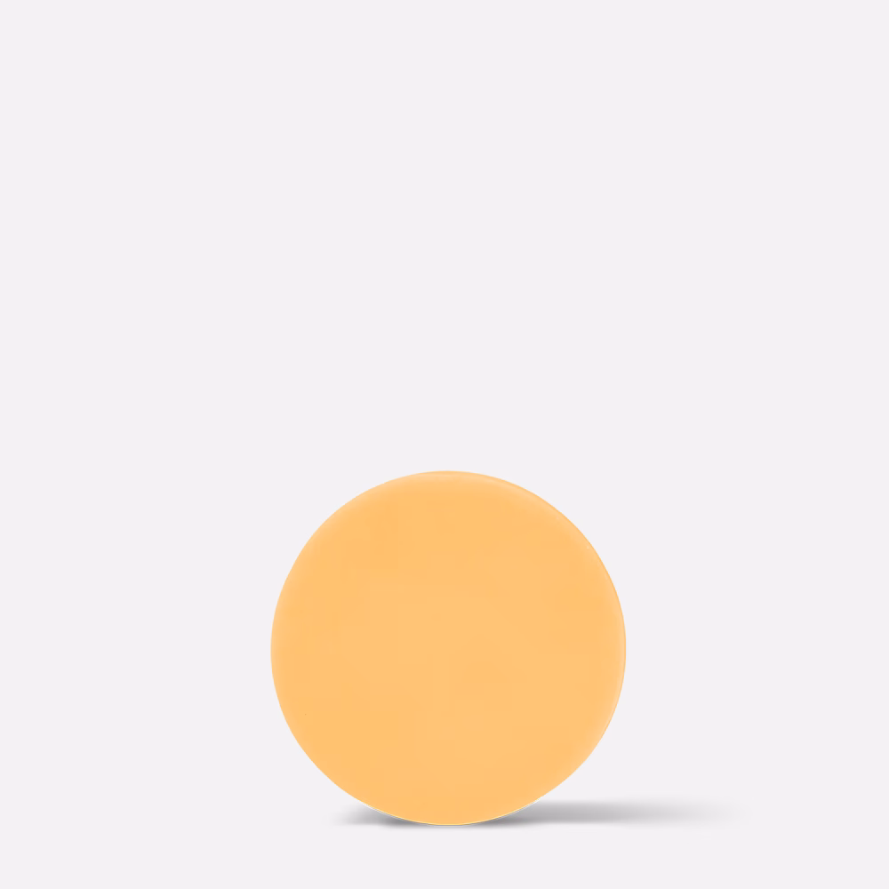 Orange round soap on white background.