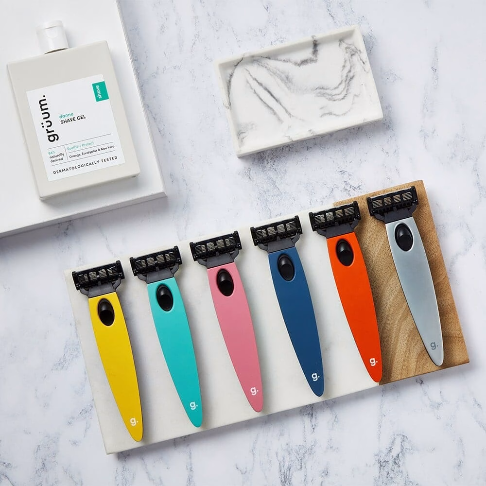 Gruum product image with danne shave gel and all colours of razor handles and blade cartridges