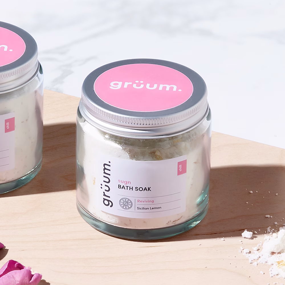 Glass jar of bath soak on wood