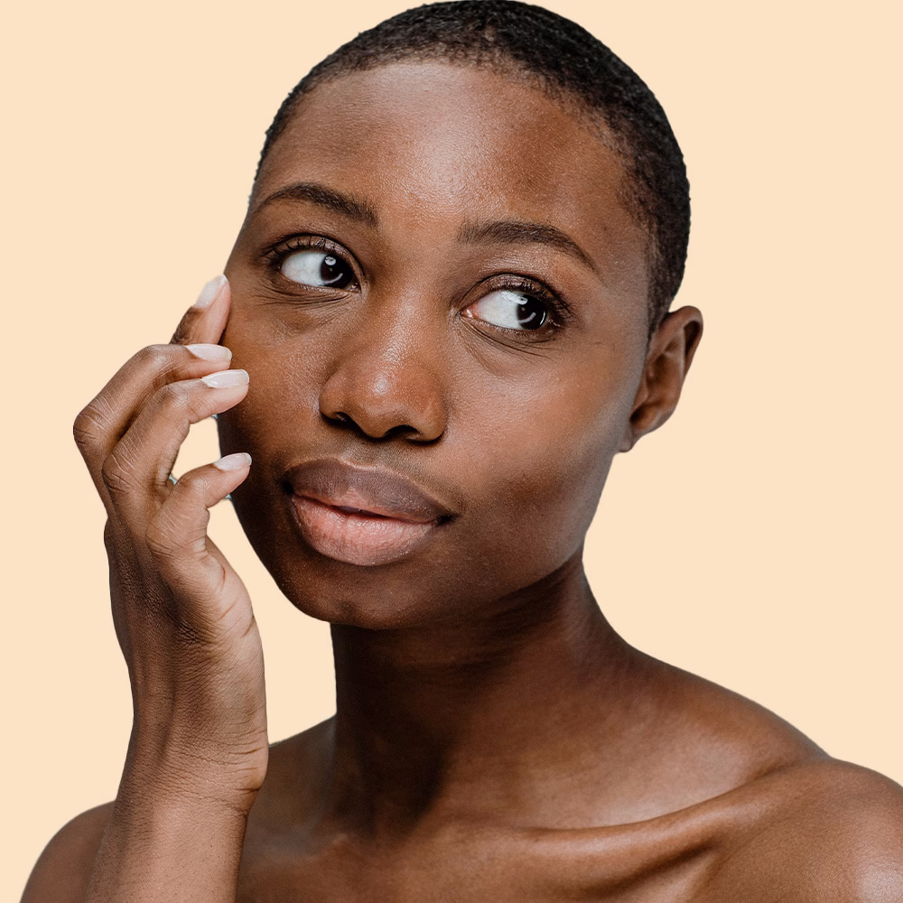 Person touching their face, looking thoughtful.