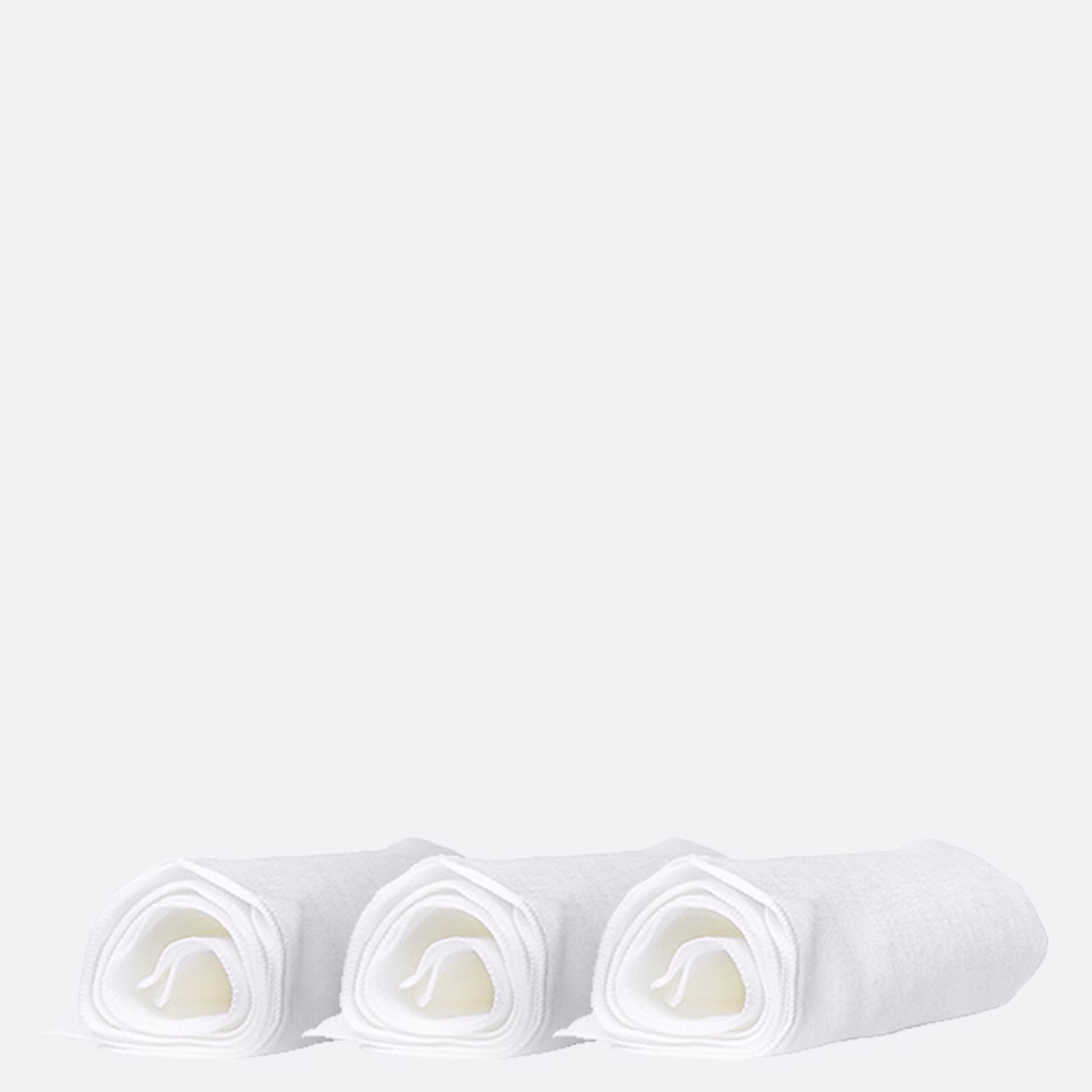 Three rolled white towels