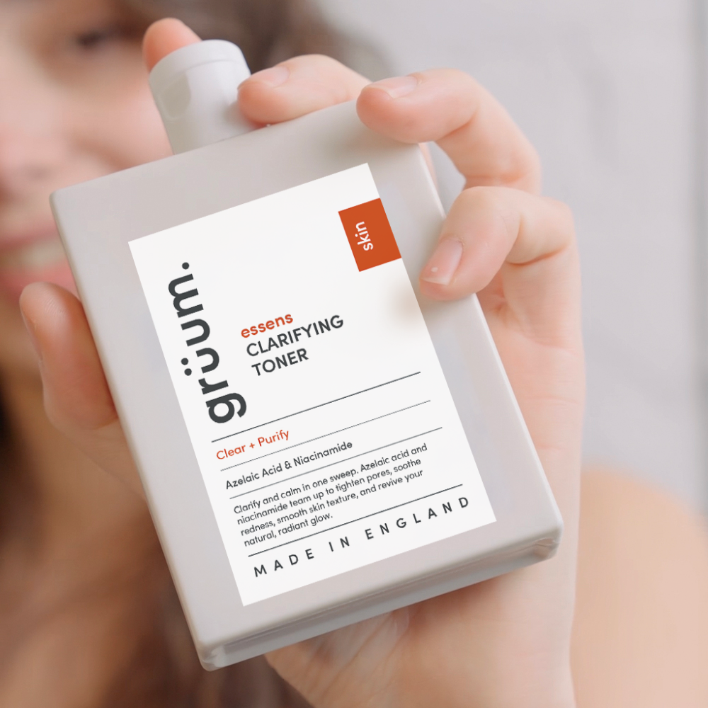 Person holding clarifying toner bottle