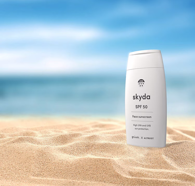 Sunscreen bottle on sandy beach