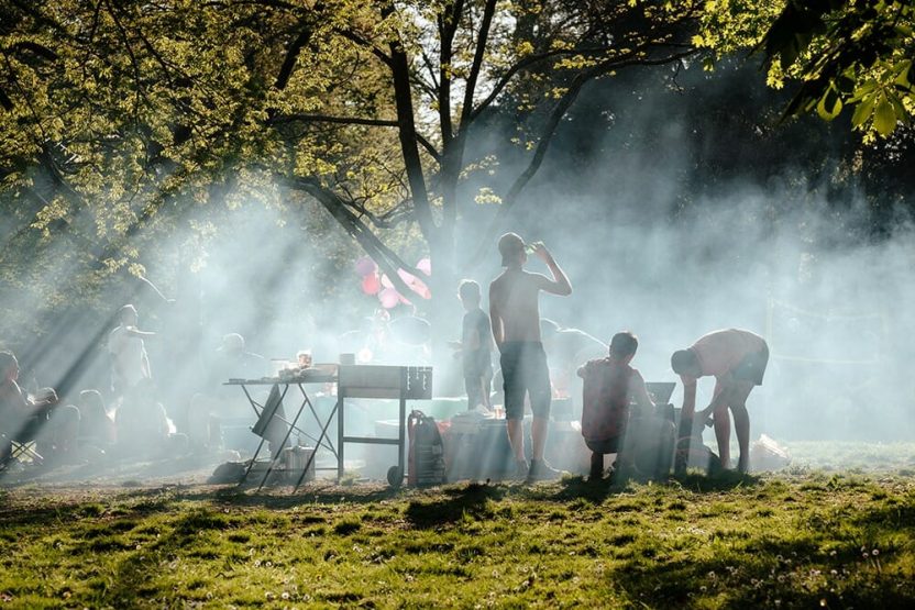 People gathered for a picnic under trees.