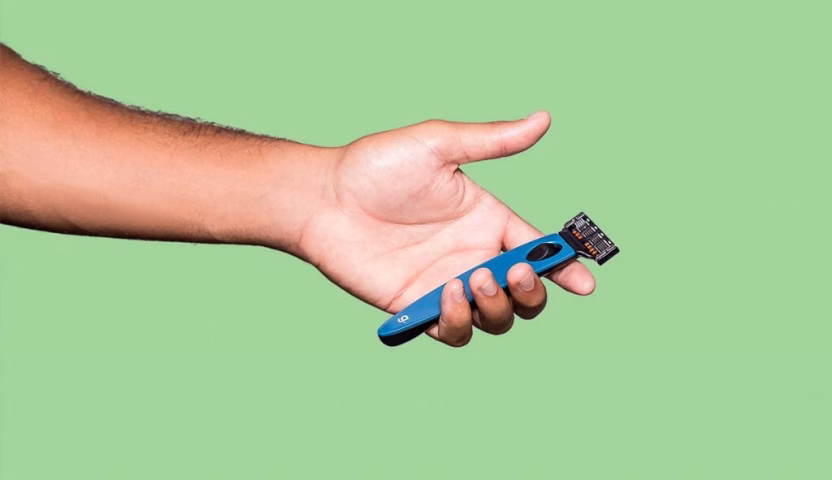Hand holding blue razor