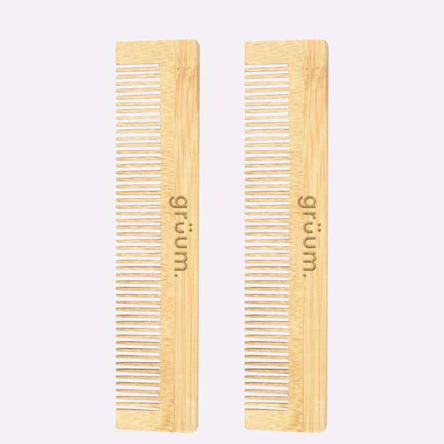 Two wooden combs with text.