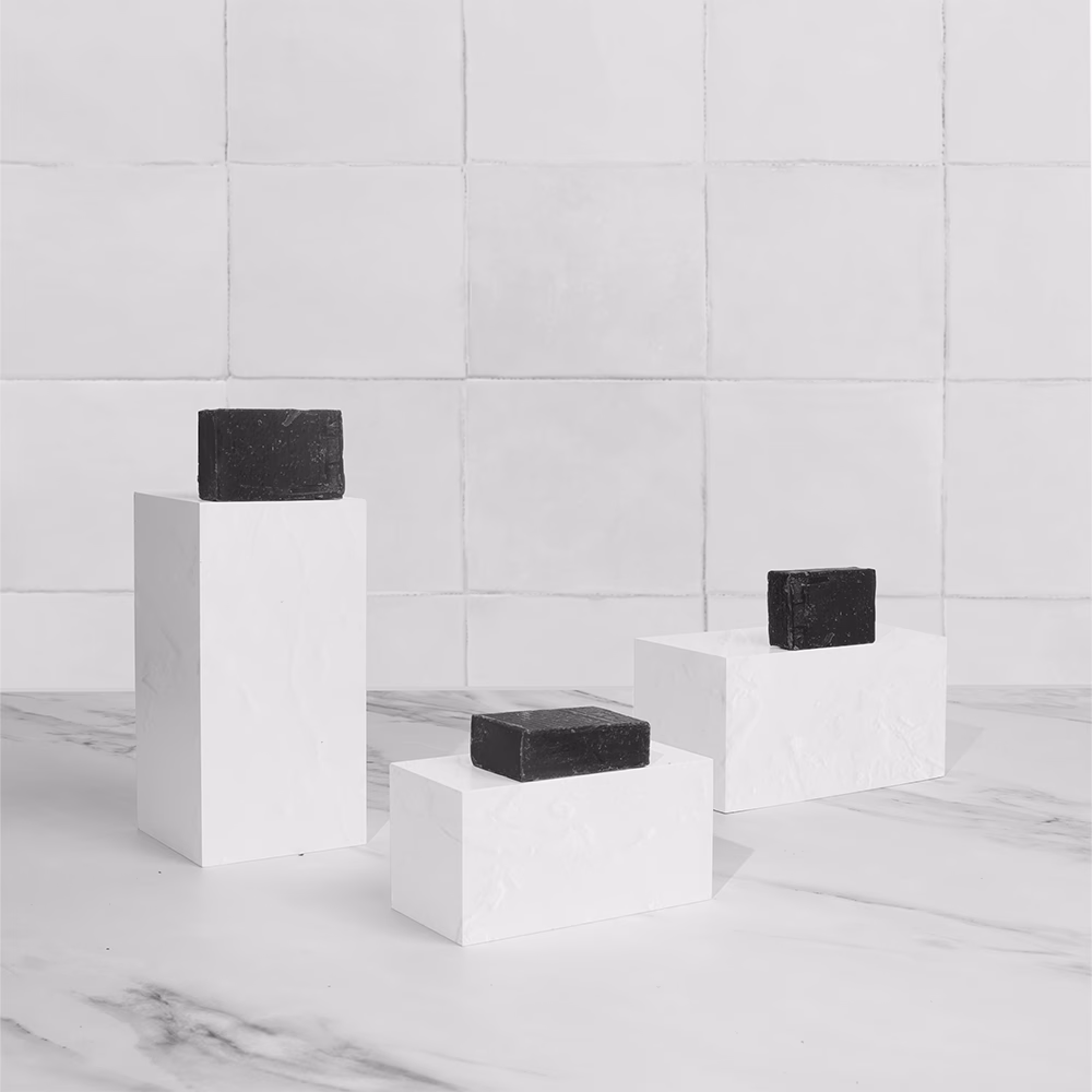 Black soaps on white pedestals