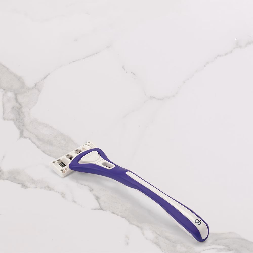 Purple razor on marble surface.