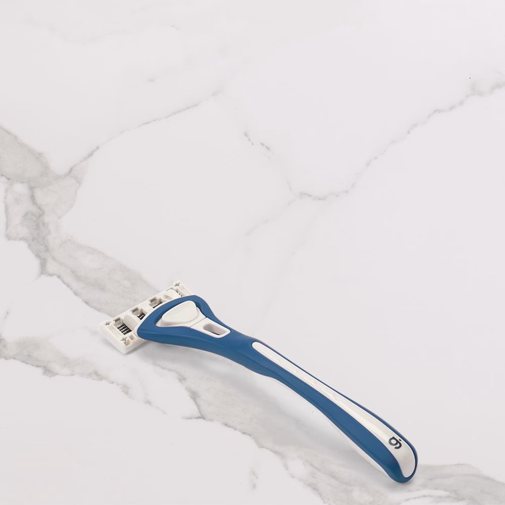 Blue razor on marble surface