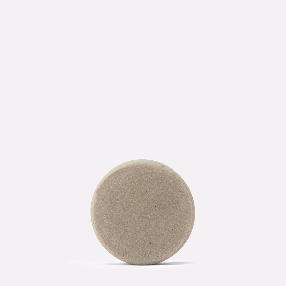 Round beige stone on white background.