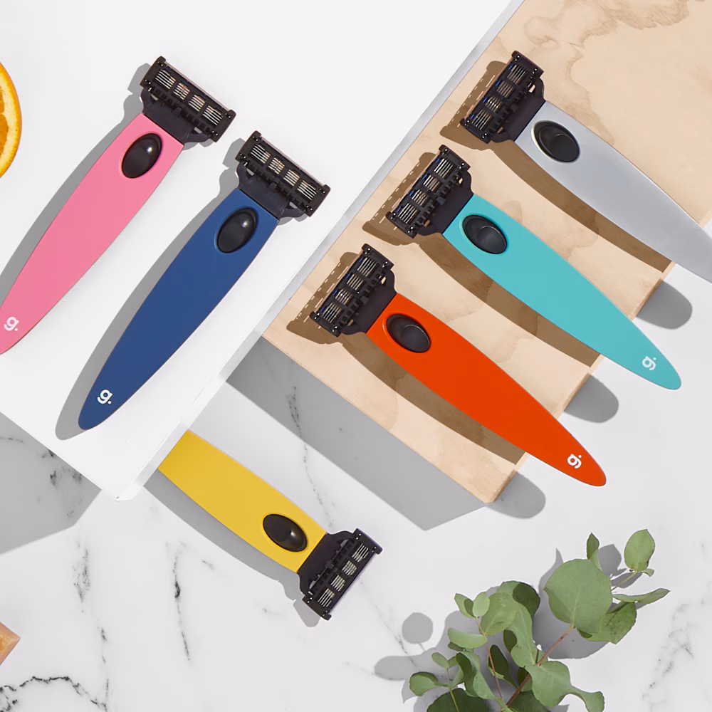 Colorful razors on marble surface.