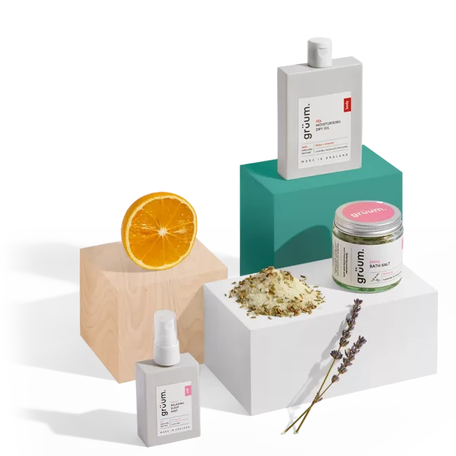 Assorted skincare products with orange slice.