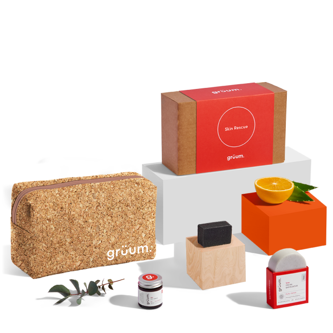 Skincare products with cork bag and orange.