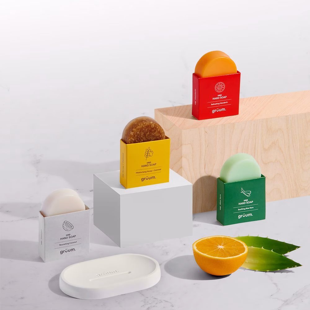 Colorful soap bars on marble surface.
