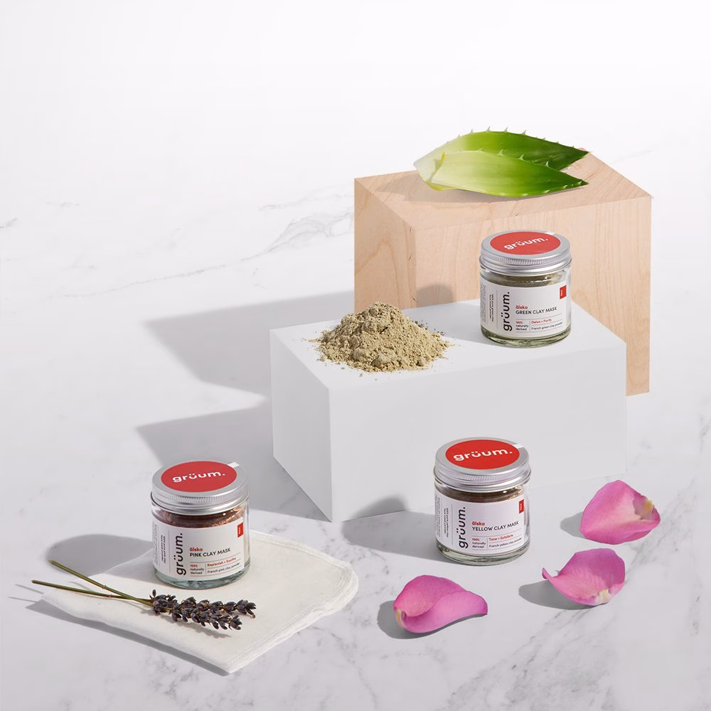 Clay mask jars with petals and leaves