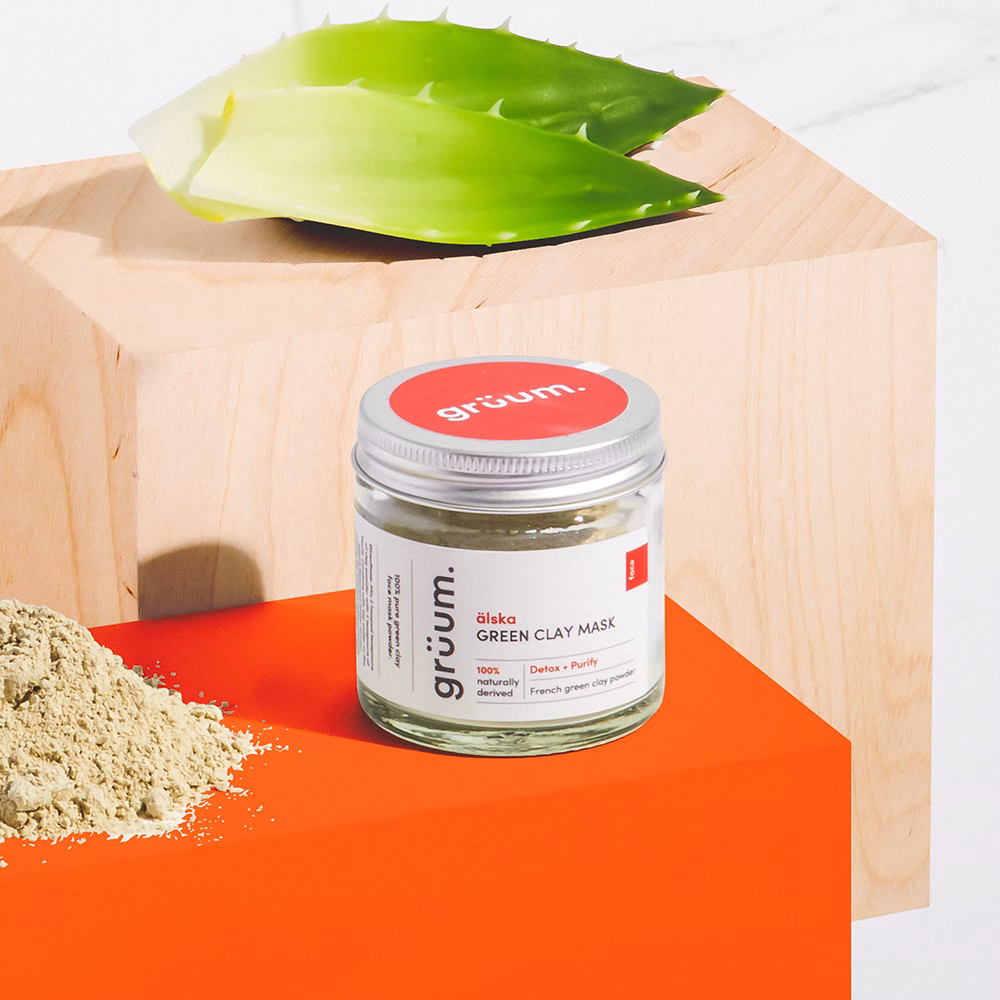 Green clay mask jar with aloe leaf