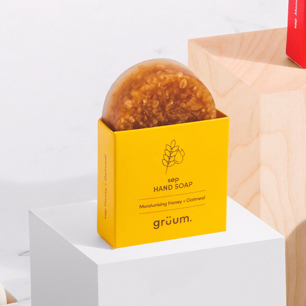 Honey oatmeal soap in yellow packaging.