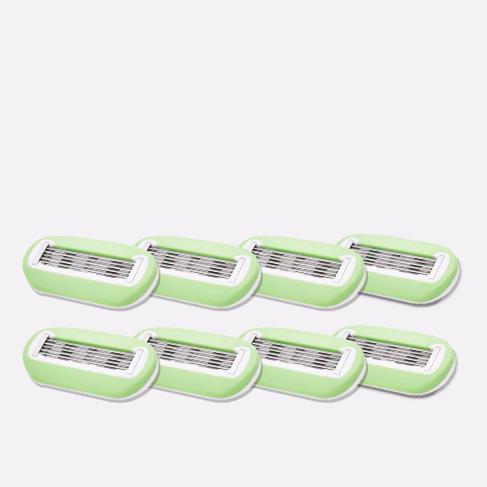 Eight green razor blade refills