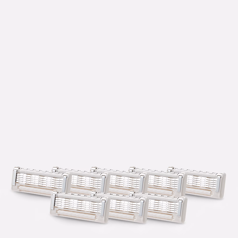 Seven razor cartridges stacked together.