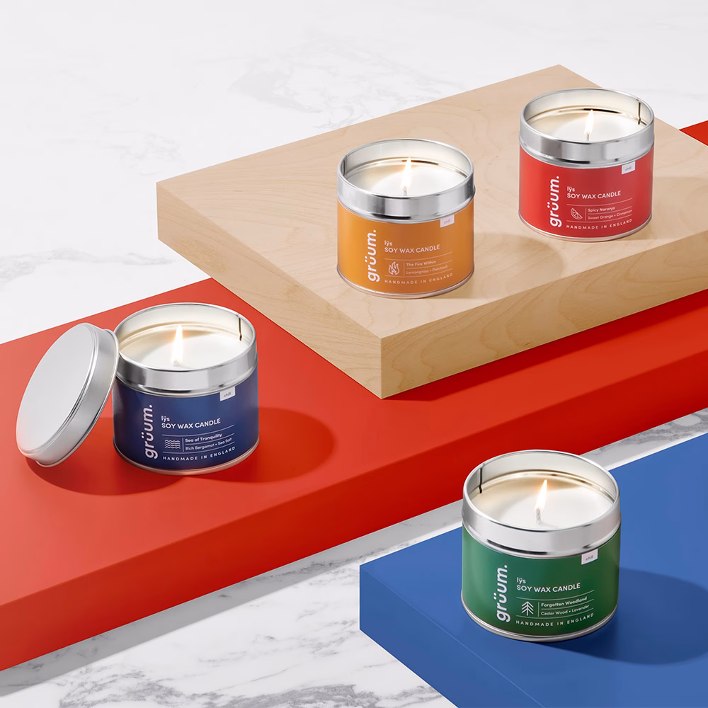 Four colored soy wax candles displayed.