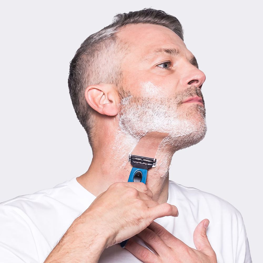 Man shaving neck with razor