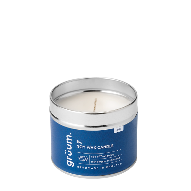 Blue soy wax candle in a tin.