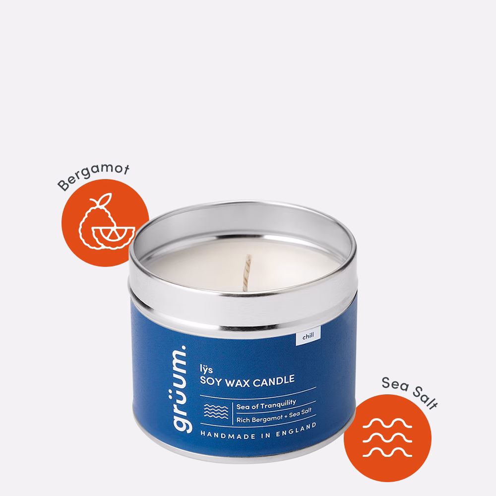Blue soy wax candle with lid off.