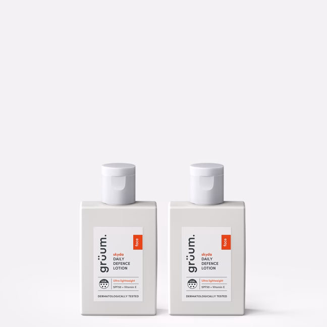 Two bottles of skincare lotion.