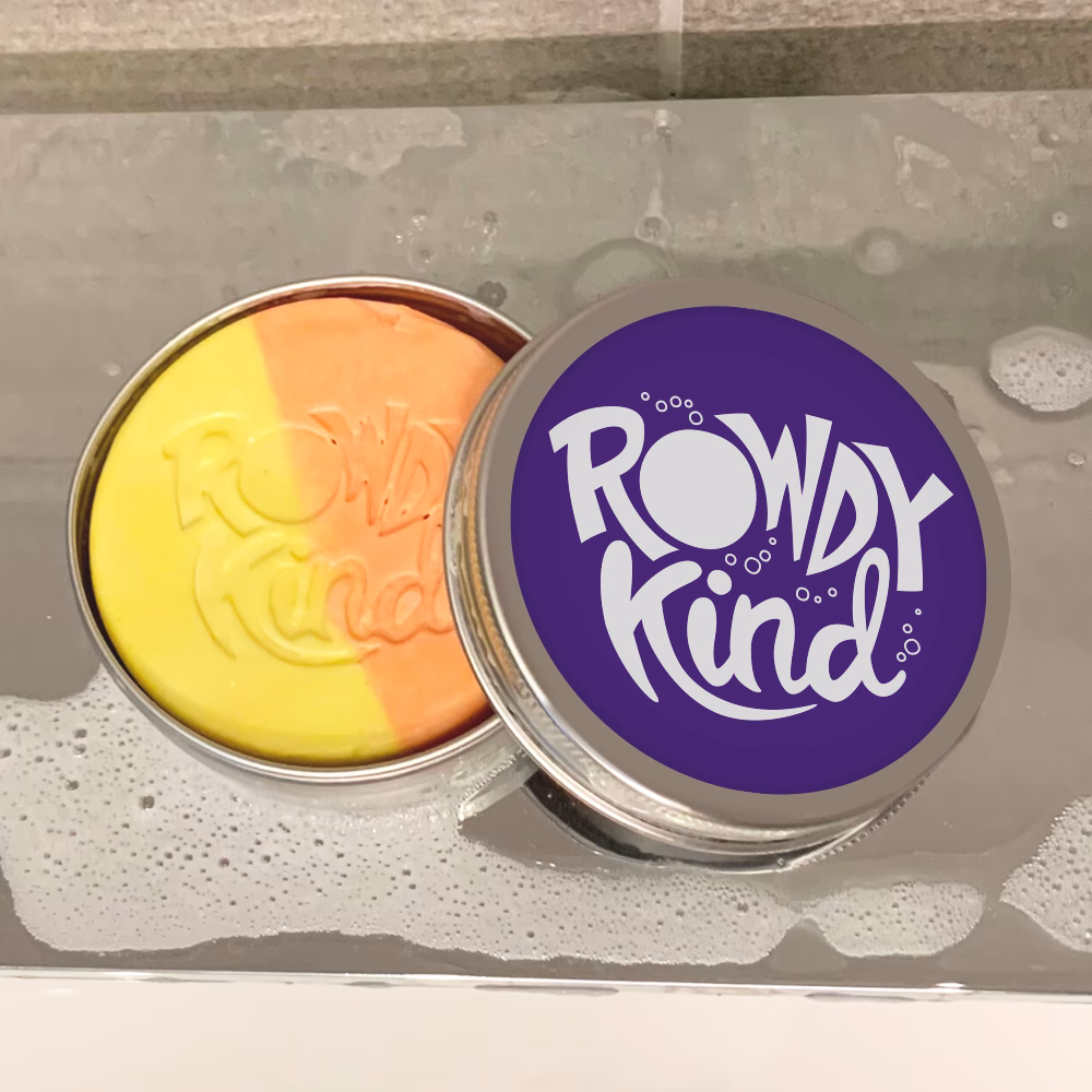 Two-tone soap in tin on tiles.
