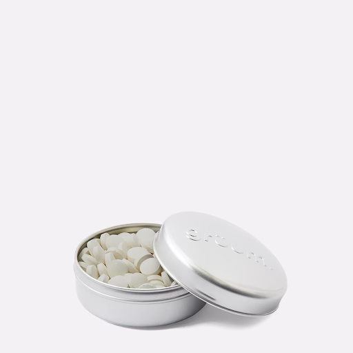Open tin with small white tablets