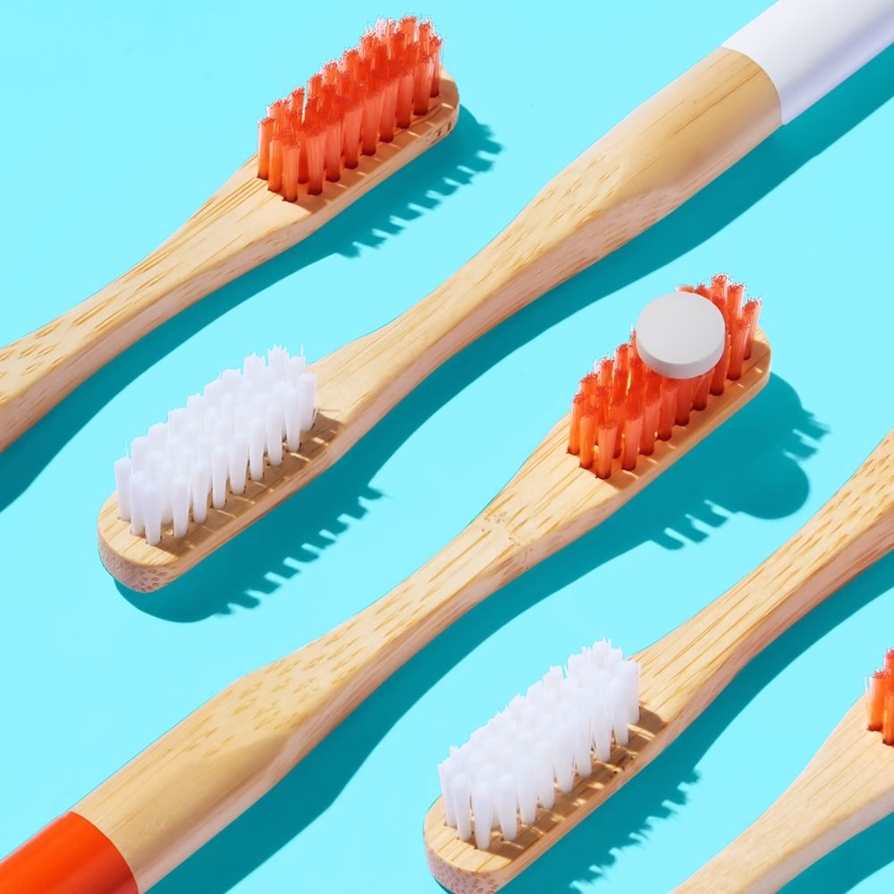 Bamboo toothbrushes on blue background.