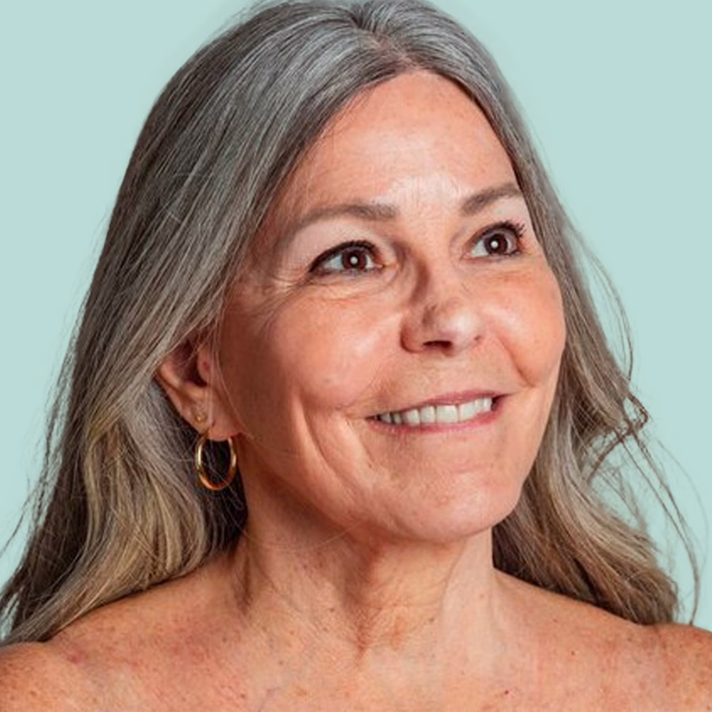 Smiling woman with gray hair.