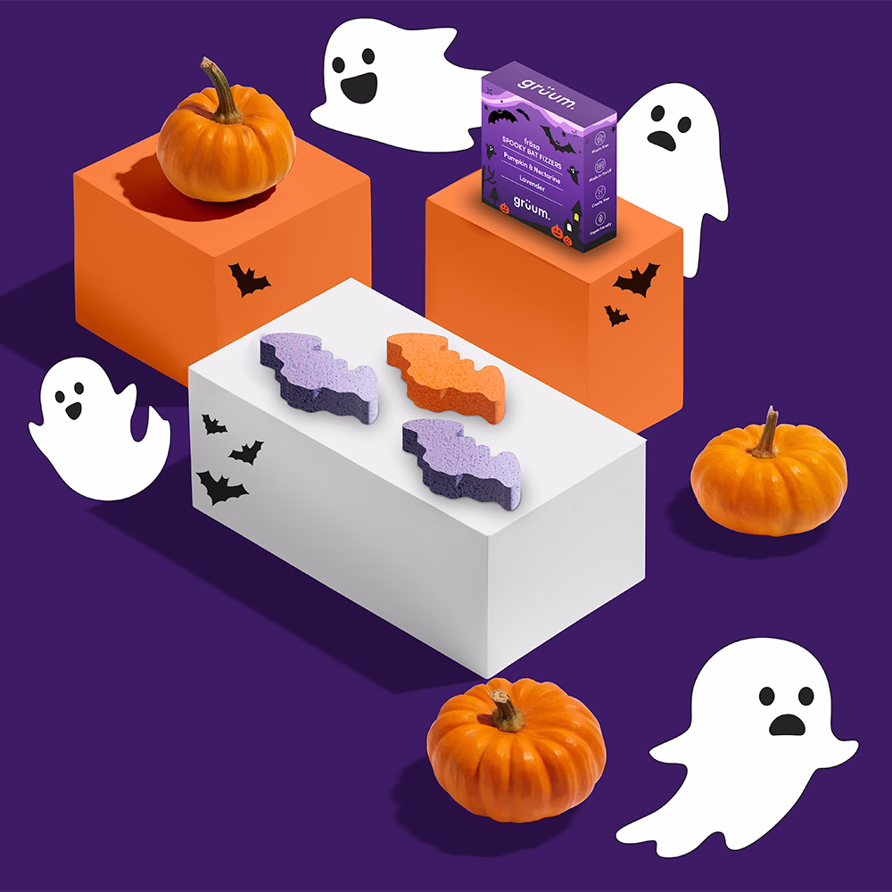 Colorful Halloween-themed arrangement with pumpkins and ghosts.