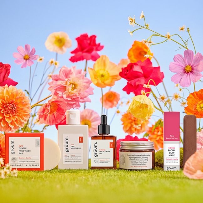 Skincare products with colorful flower background.