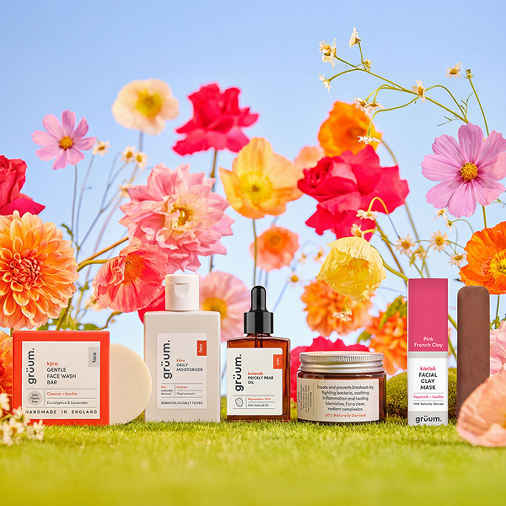 Skincare products with colorful flower background.