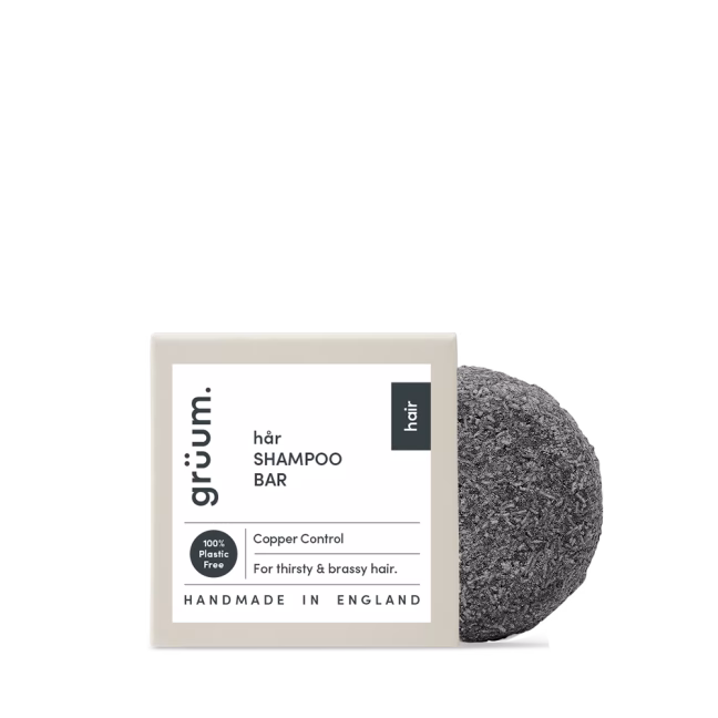 Black shampoo bar with packaging.