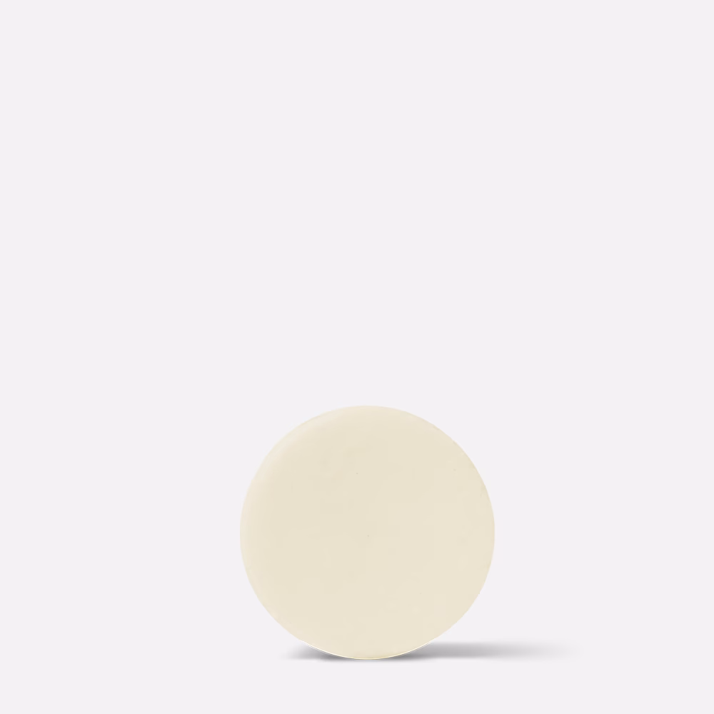 Beige round object on white background.