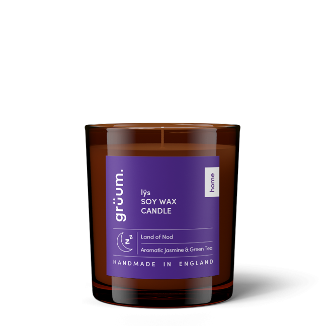 Purple soy wax candle in glass jar.