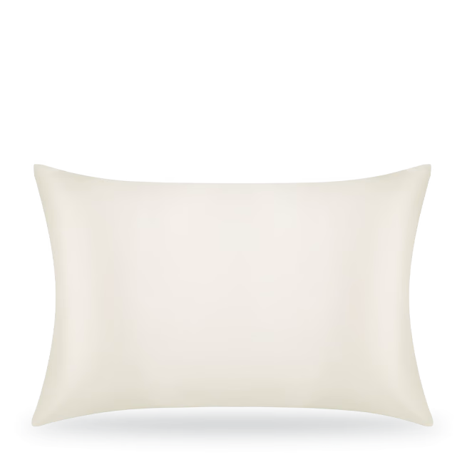 Plain white pillow on bed