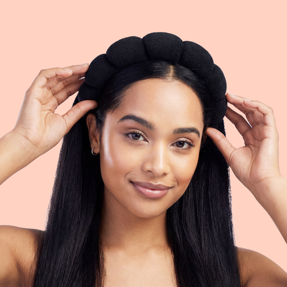 Woman adjusting a black headband
