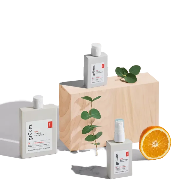 Skincare products with orange and leaves.