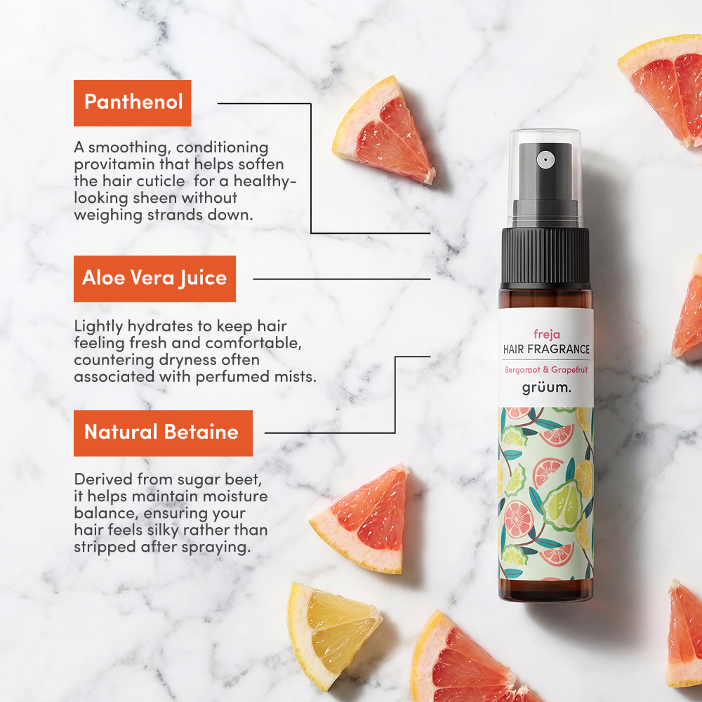 Hair fragrance bottle with grapefruit slices.