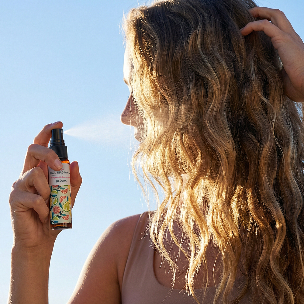 Woman spraying hair with mist