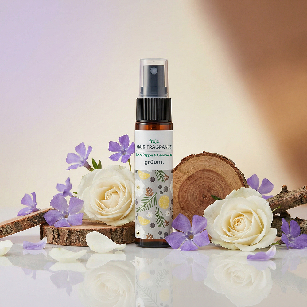 Hair fragrance with flowers and wood background.
