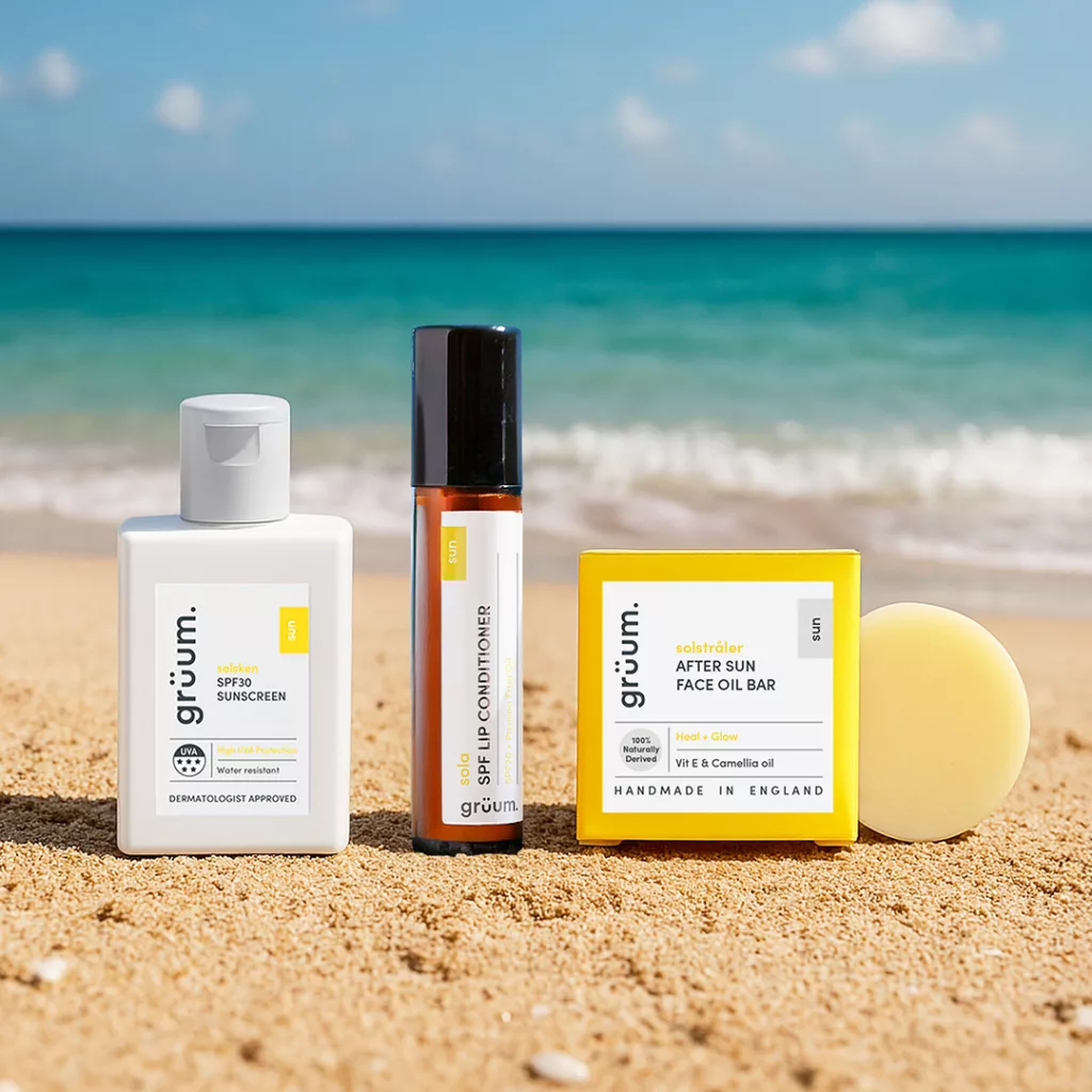 Skincare products on a sandy beach.